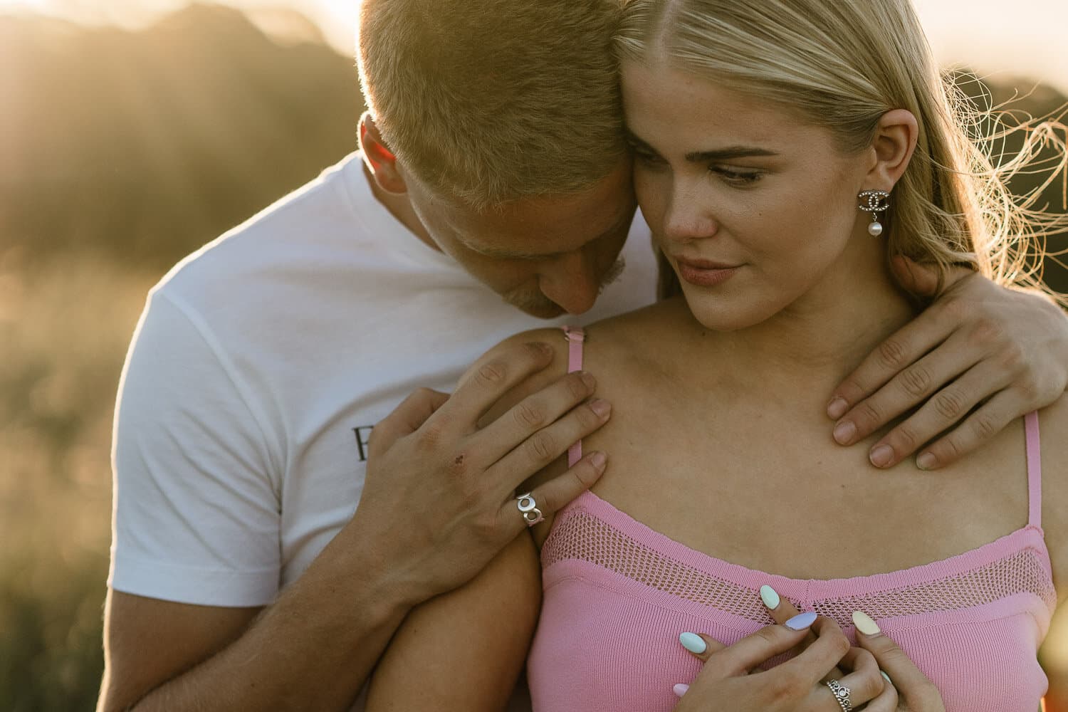 Couple embracing at sunset on a Sydney headland