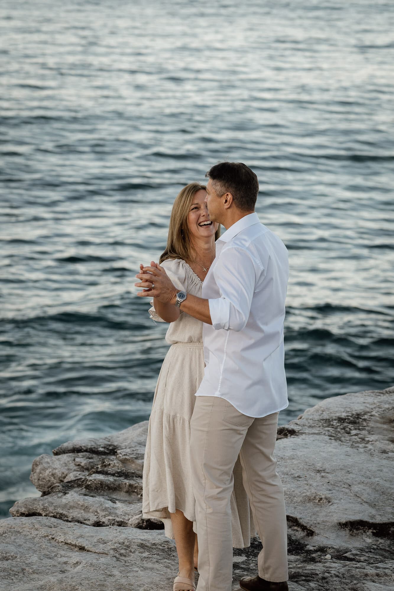 Couple together on the rocks above the water