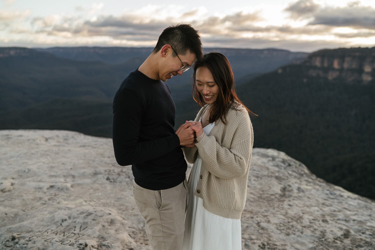 Couple together on a clifftop above the Blue Mountains valley