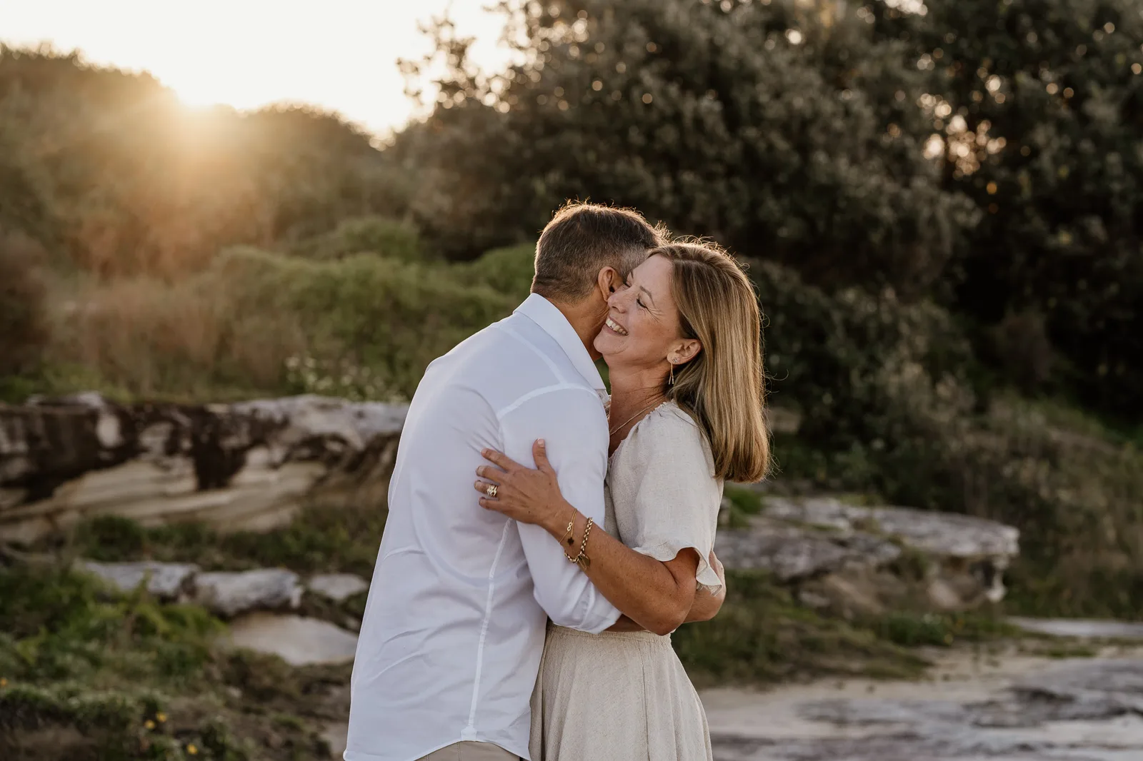 Couple embracing on the coast at golden hour during a Sydney couples session