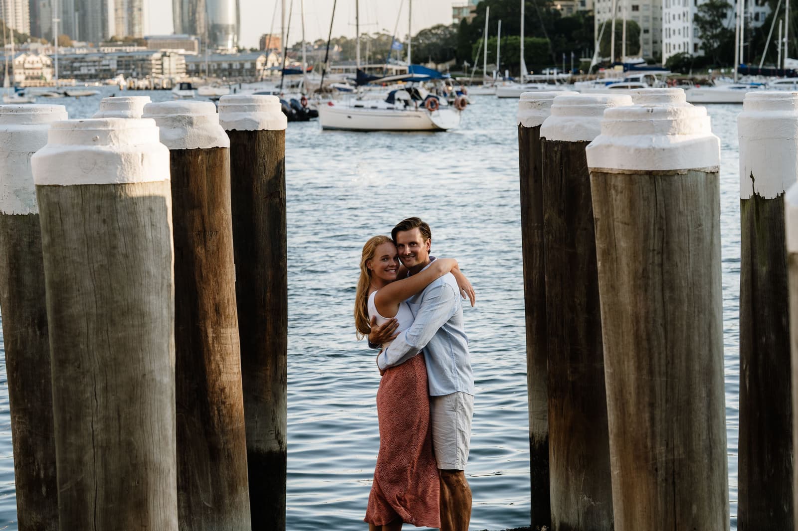 Couple walking a grassy hill at sunset during a candid couples photography session in Sydney