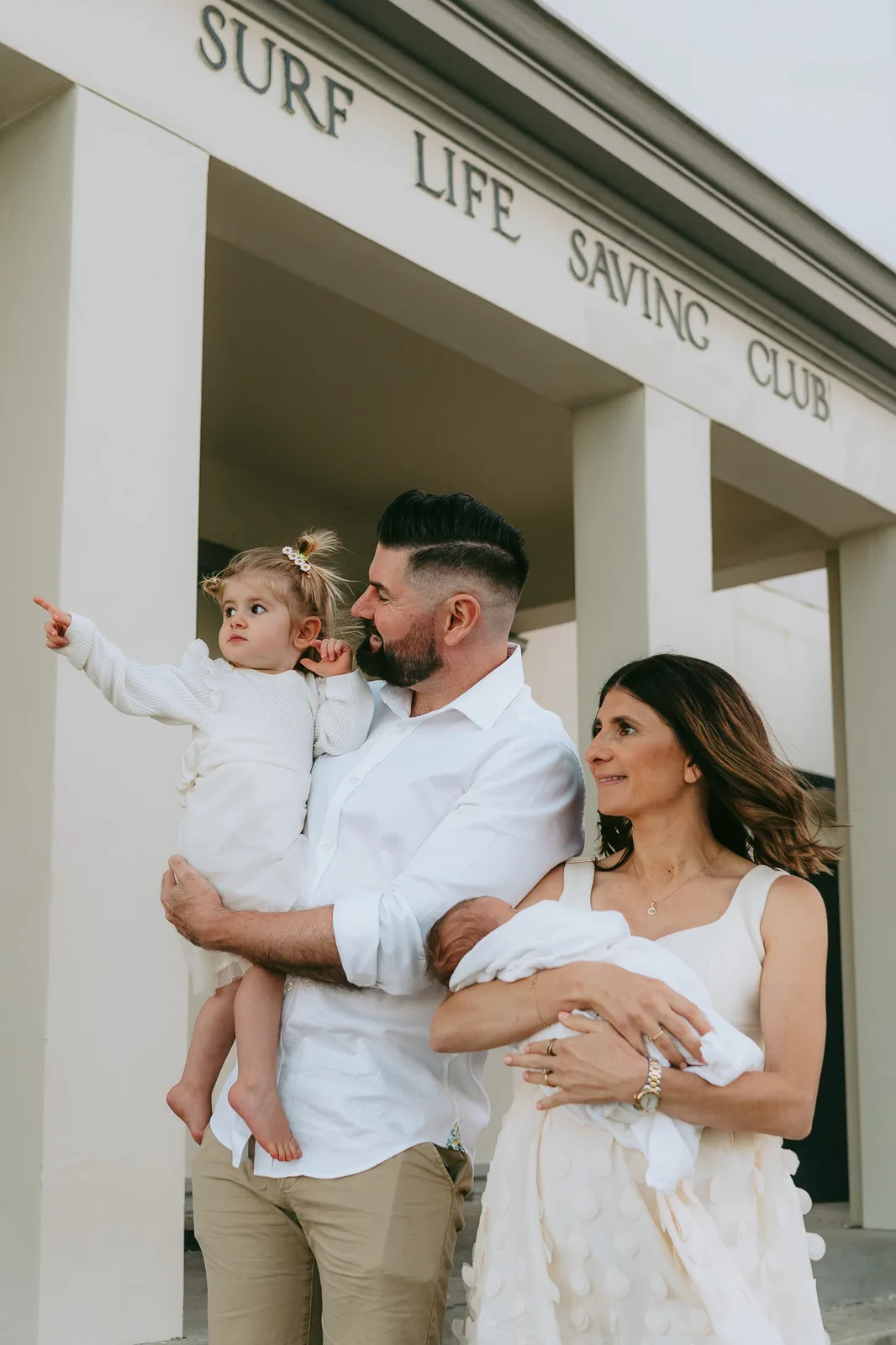 Family outside a Sydney surf life saving club during a beach photoshoot