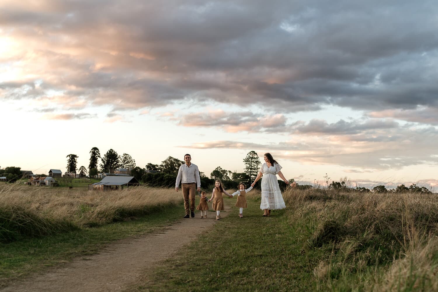 Family walking a bush path at dusk during a Hills District family session
