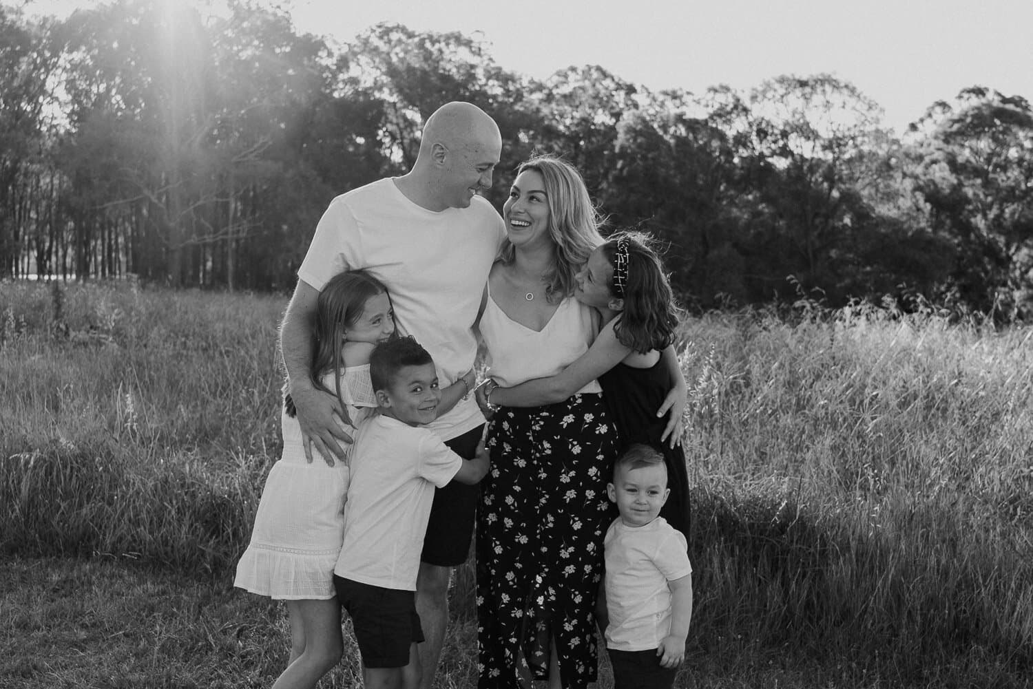 Black and white family photograph in a Sydney field