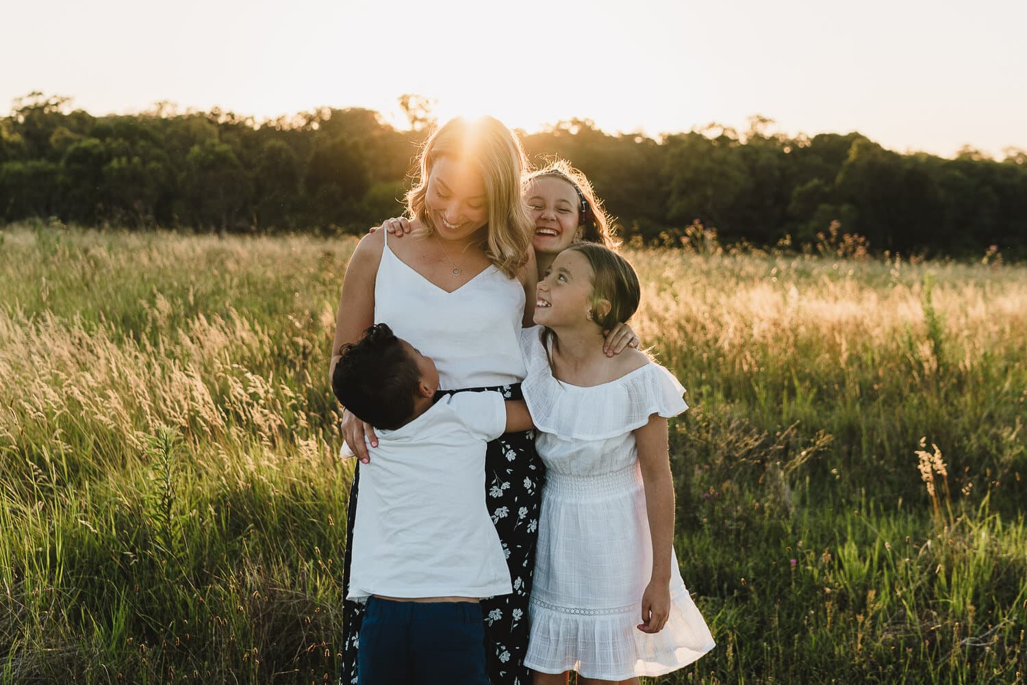 Mother and her 2 daughters in long grass during a Sydney family session