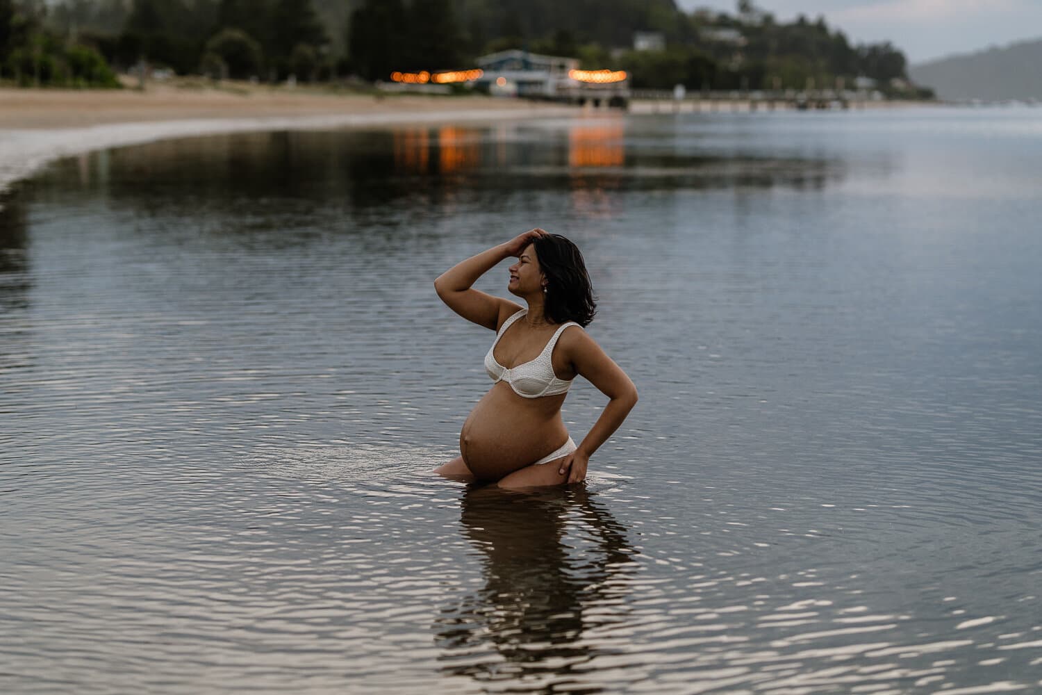 Expecting mother in the shallows of a Sydney beach at first light