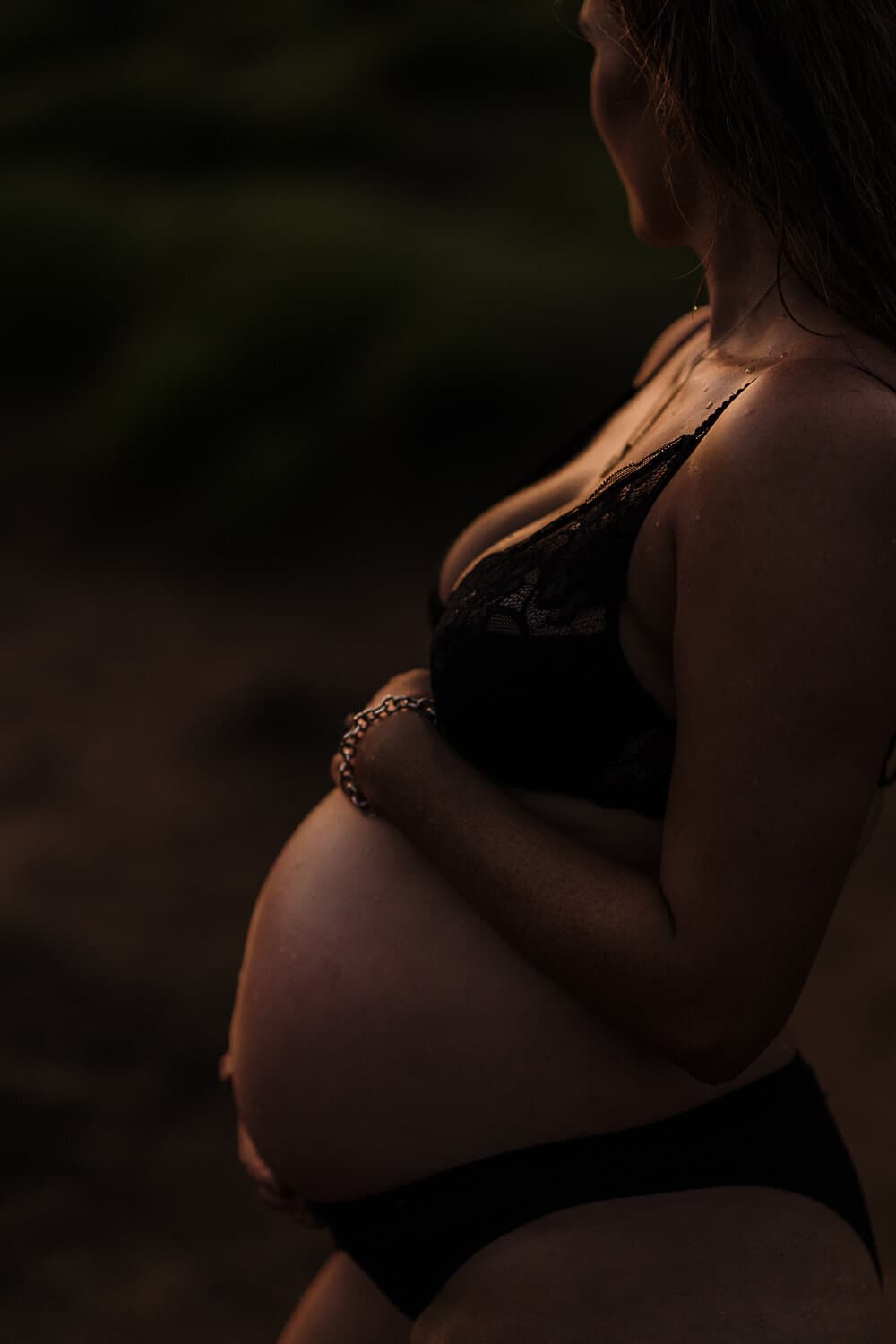 Close frame of a pregnant belly in low evening light