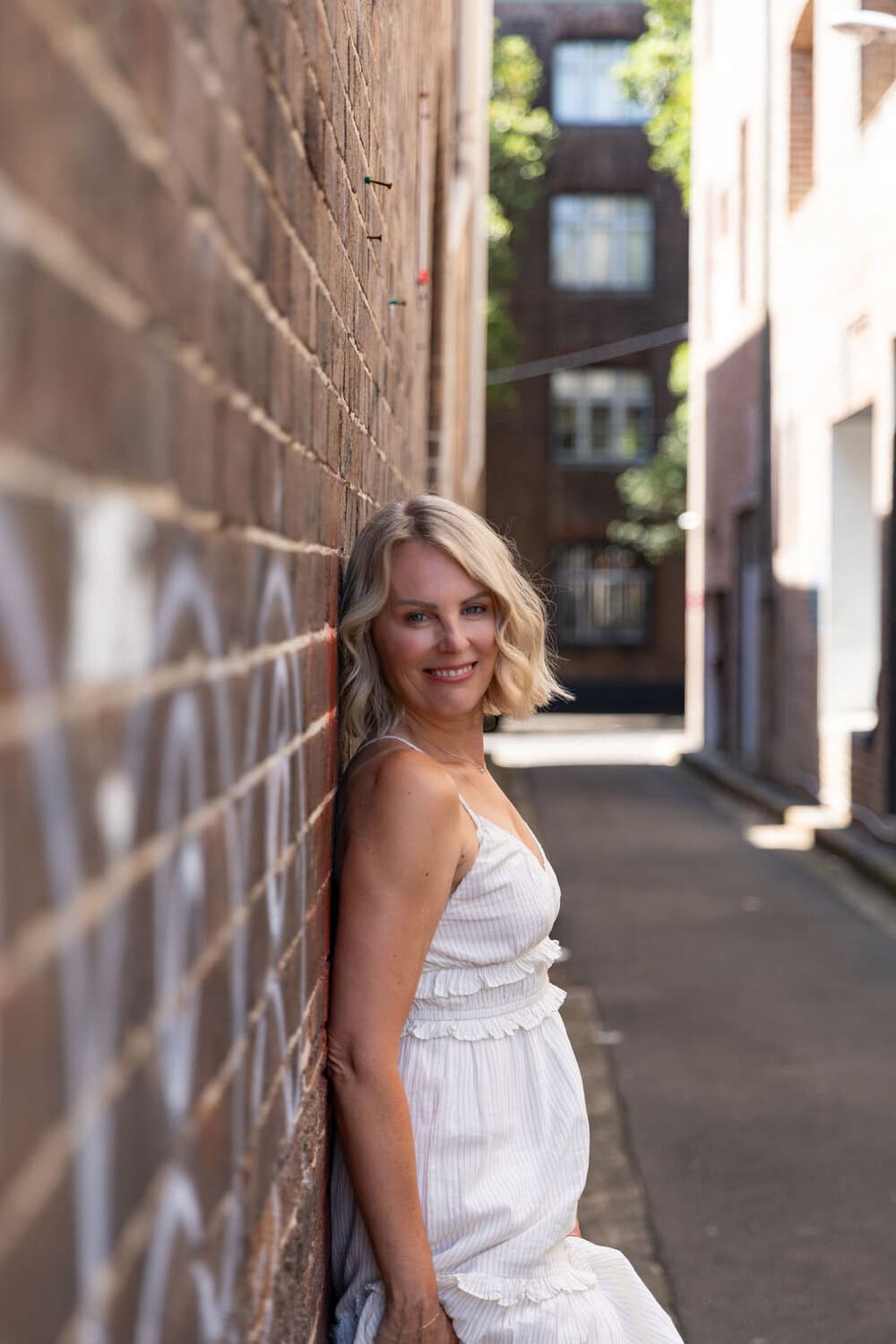 Nerissa, professional photographer and owner of Nerissa J Photography, in a Sydney laneway