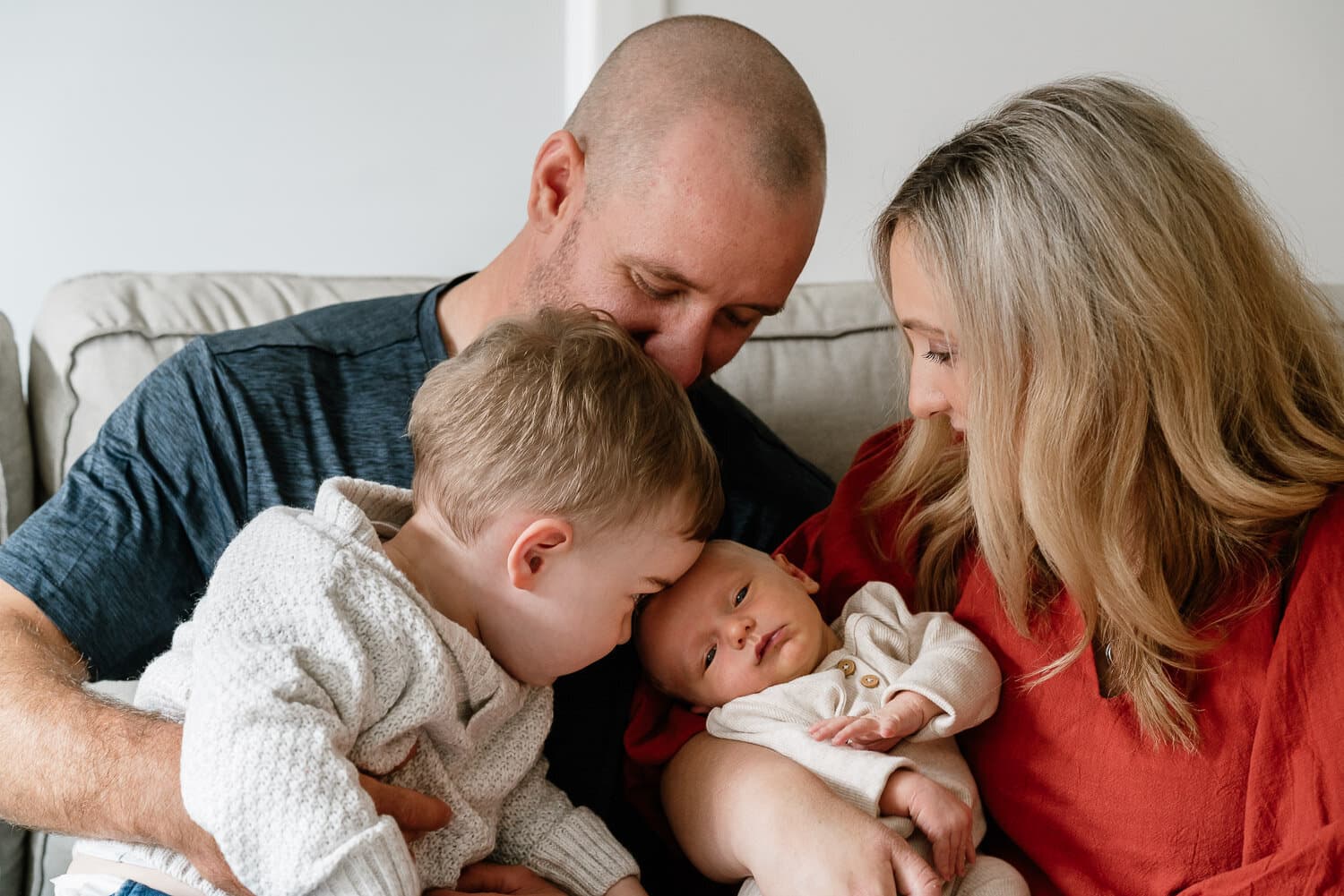 Parents and big brother meeting the new baby at home