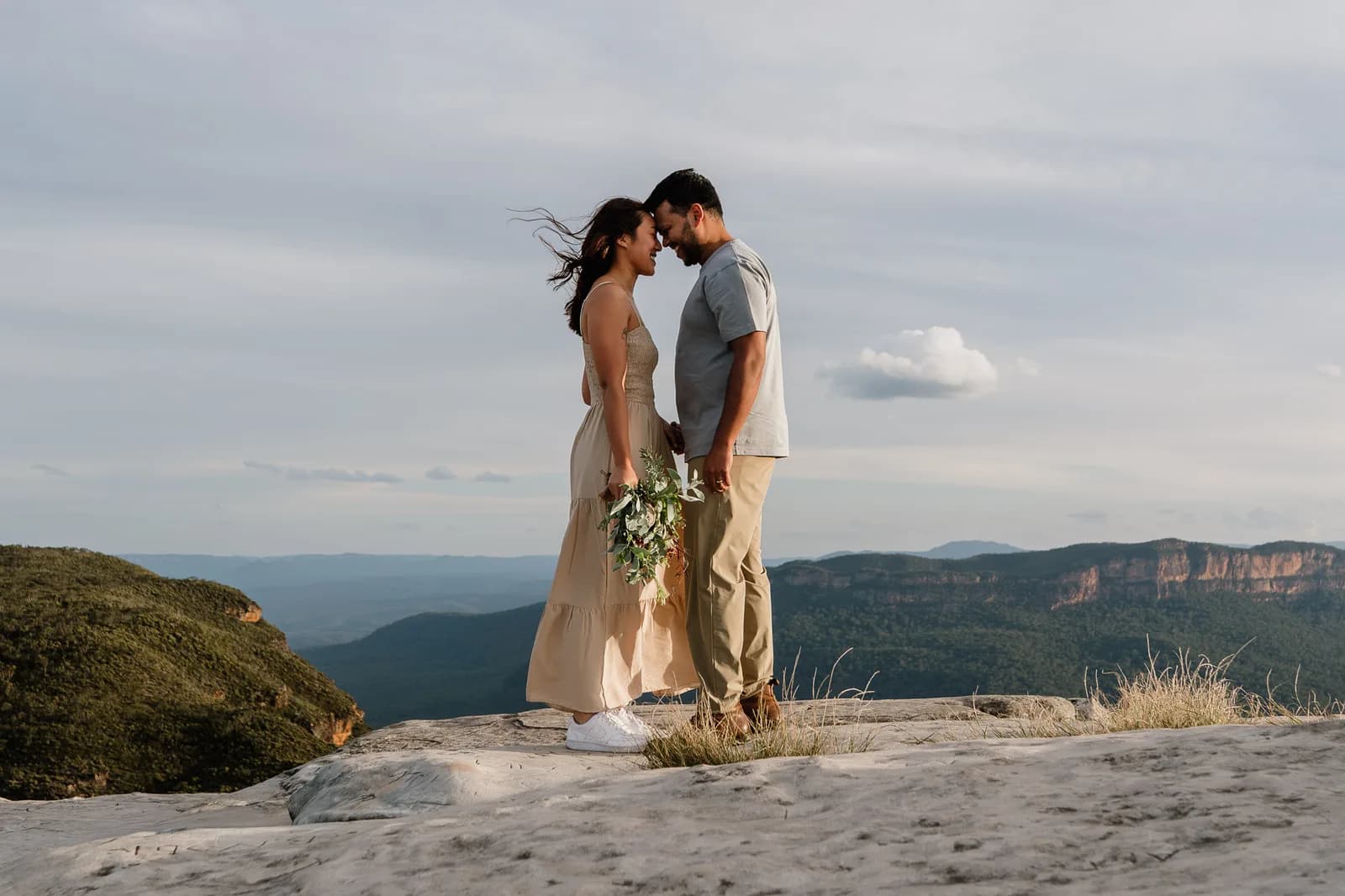 Couple embracing on a Blue Mountains clifftop after the proposal