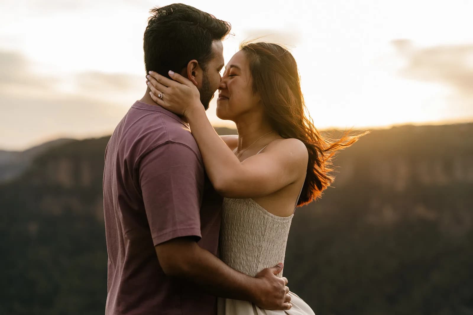 Couple kissing in golden light after a Blue Mountains proposal