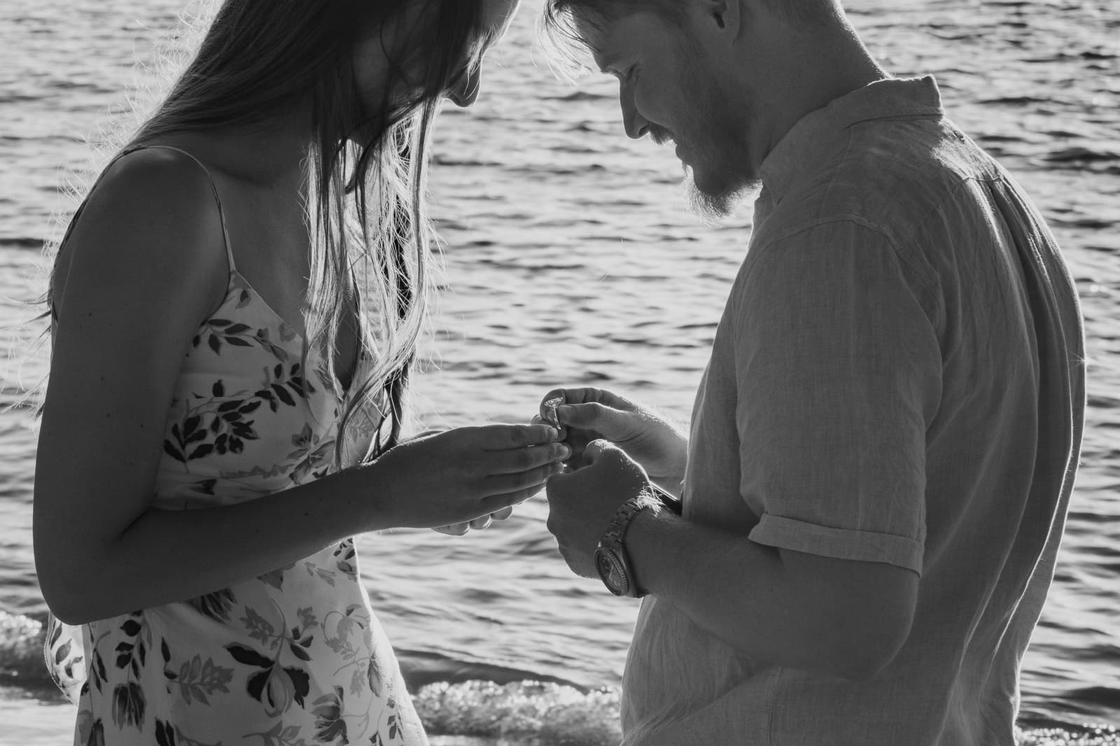 Black and white photograph of the ring going on beside the water