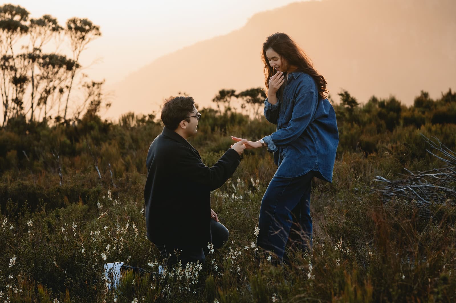 He kneels in the bushland at sunset as she realises what is happening