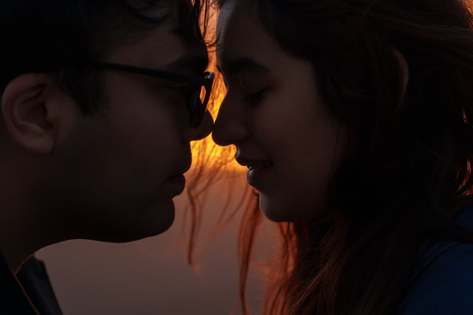 Faces close together in warm evening light after the proposal