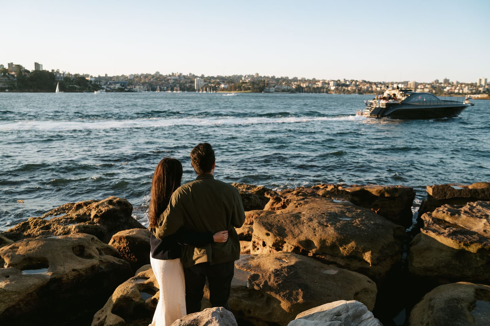 Newly engaged couple on the rocks above Sydney Harbour