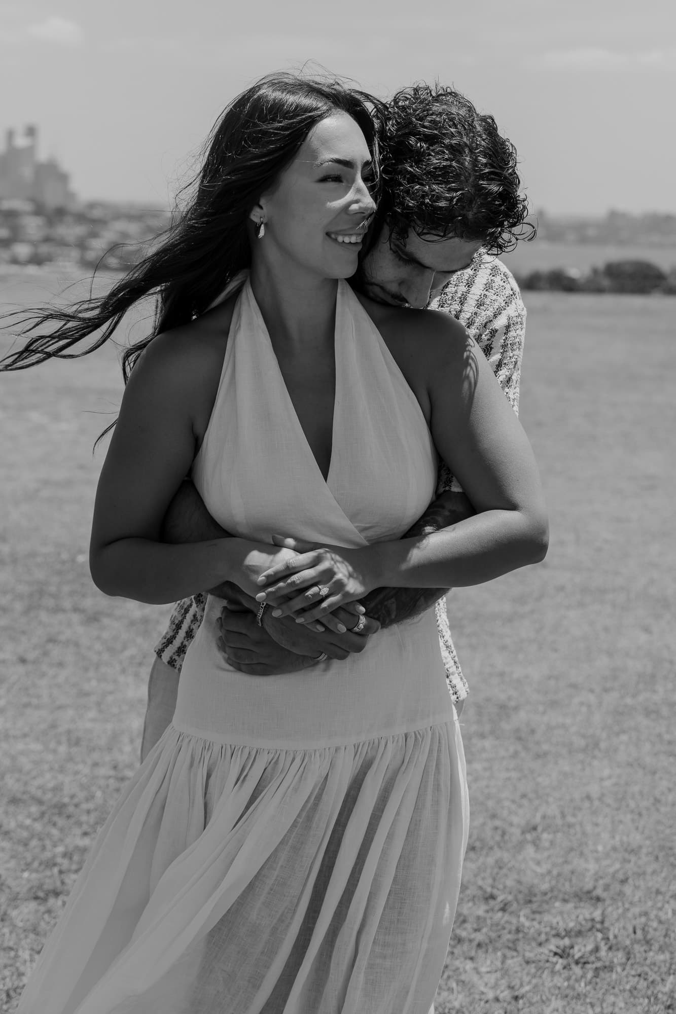 Black and white photograph of the couple laughing together after the proposal