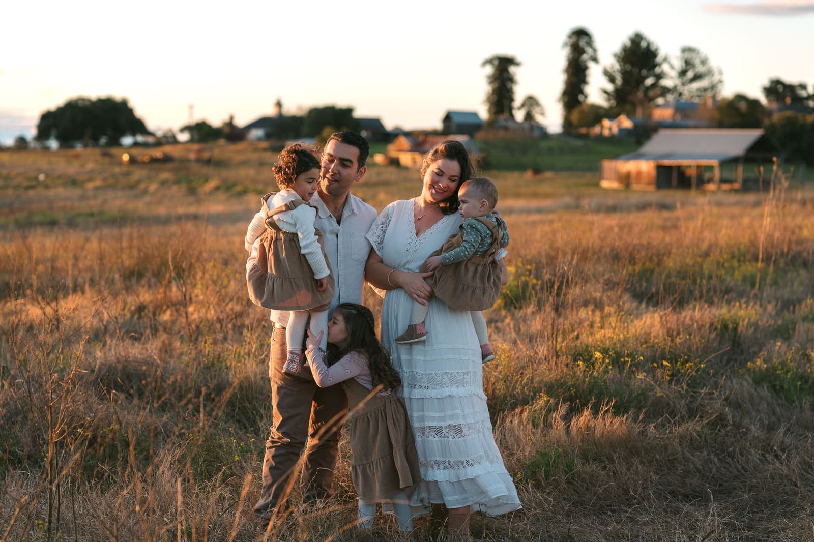 Family of five in a golden field at sunset during a Sydney family session